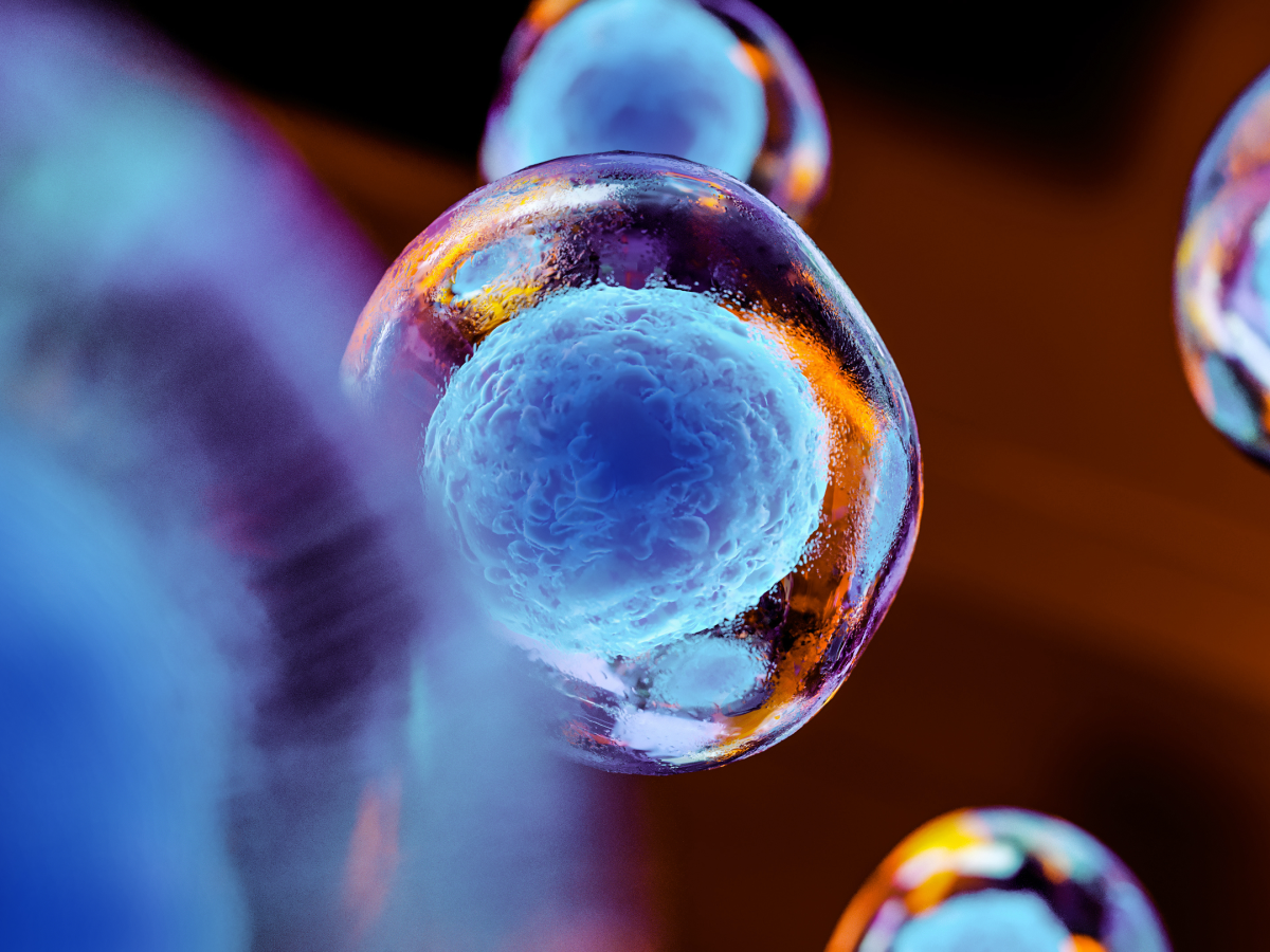 Microscopic view of glowing blue cells under magnification, with vibrant orange and blue highlights.