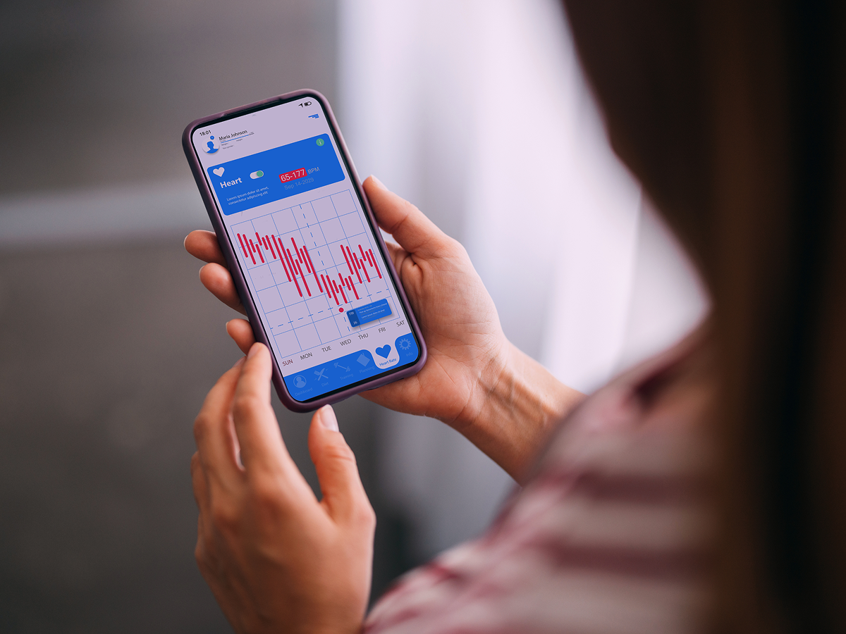 A woman checking her health app on a smartphone, focused on tracking her wellness progress