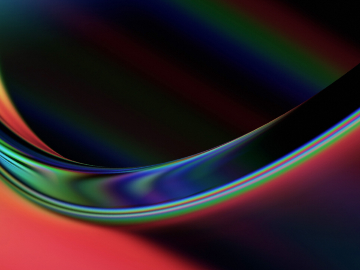 Abstract gradient with curved lines in dark tones of red, blue, and green, creating a flowing wave-like effect.