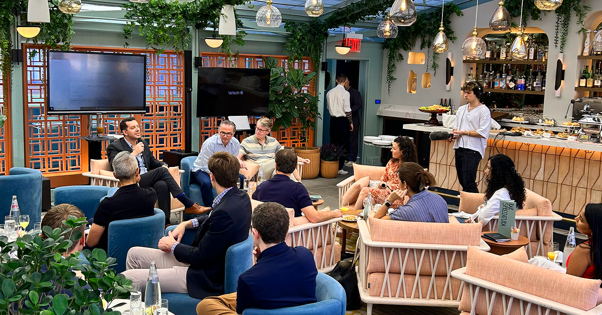 A group of people enjoying a meal together, sitting in chairs at a cozy restaurant.  
