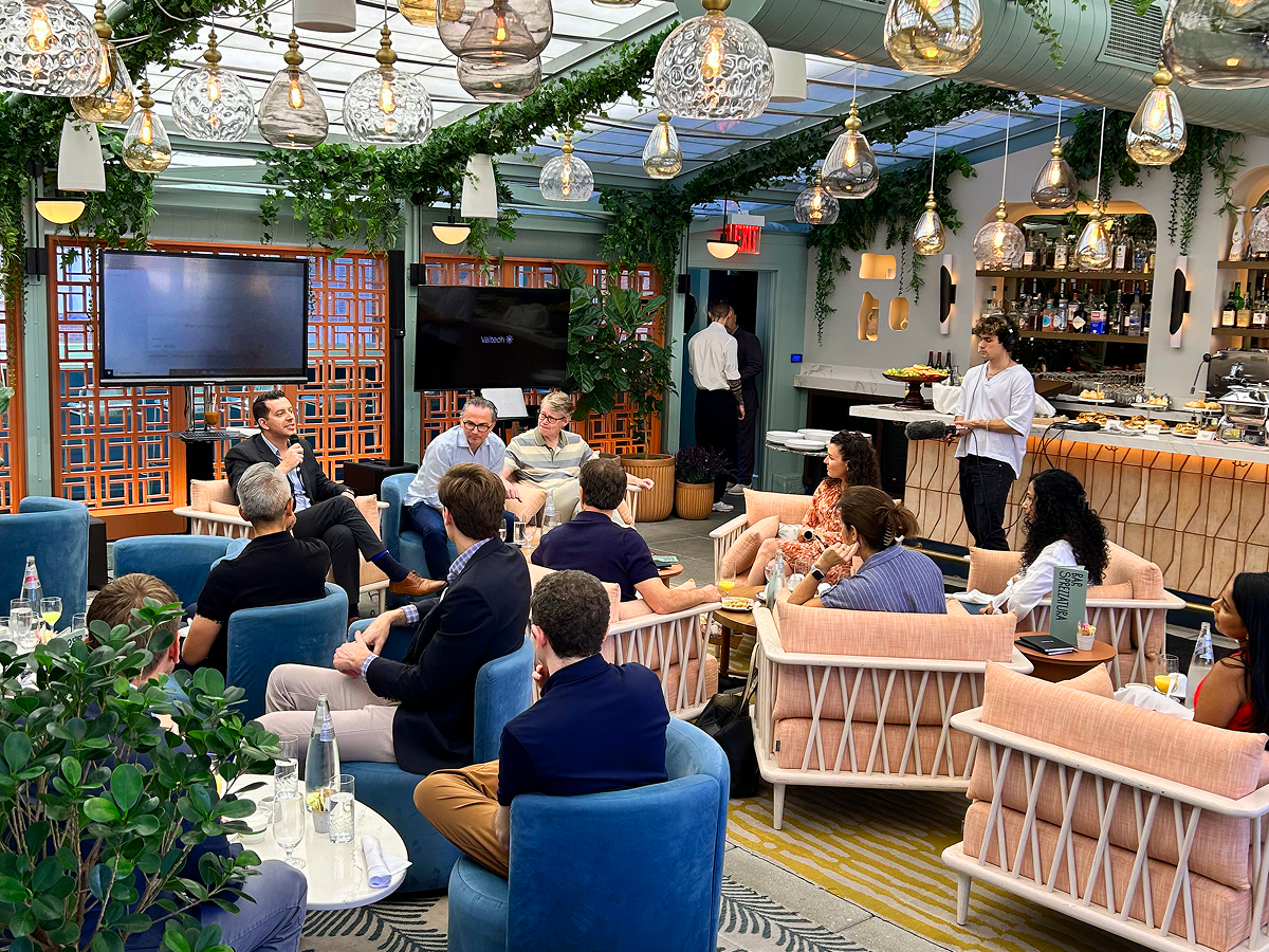 A group of people enjoying a meal together, sitting in chairs at a cozy restaurant.  