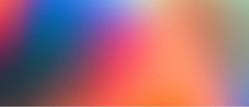 A soft, blurred mix of red, blue, and white hues in the background