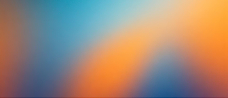 A soft, blurred mix of red, blue, and white hues in the background