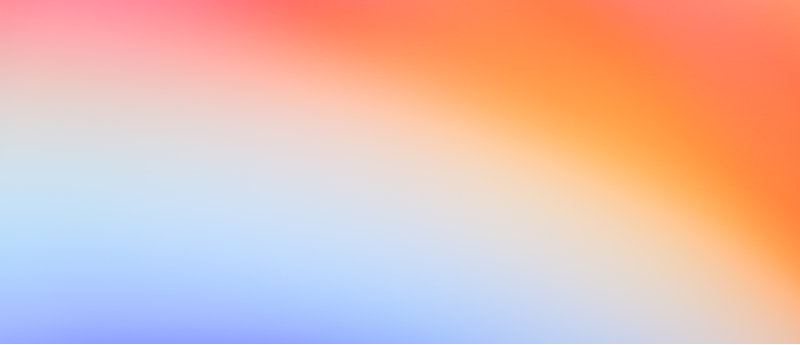 A soft, blurred mix of red, blue, and white hues in the background