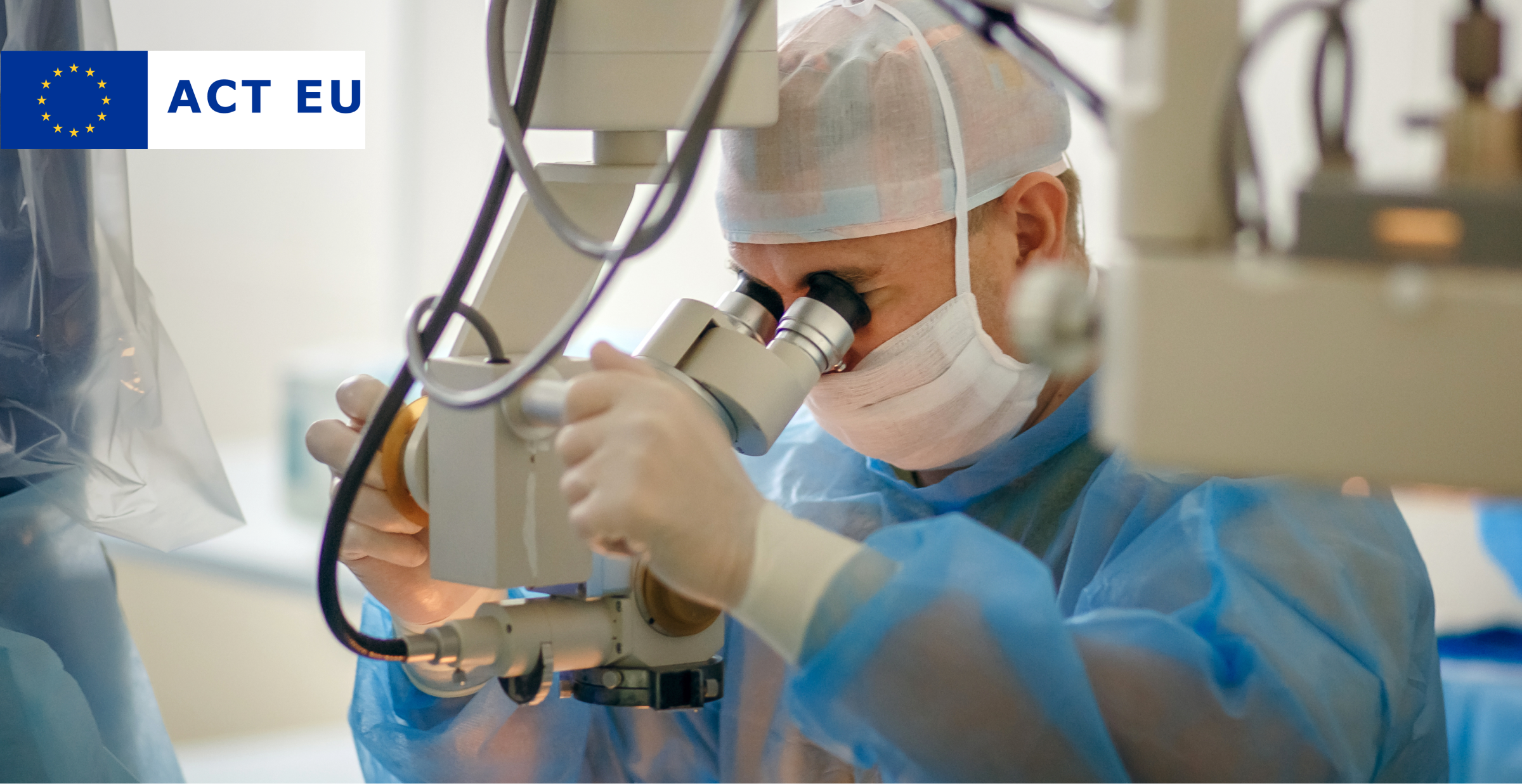 A surgeon wearing a blue surgical gown, gloves, a face mask, and a hair cap is using a high-precision operating microscope during a medical procedure. The sterile environment and advanced equipment indicate a surgical setting, likely for ophthalmic or microsurgery.