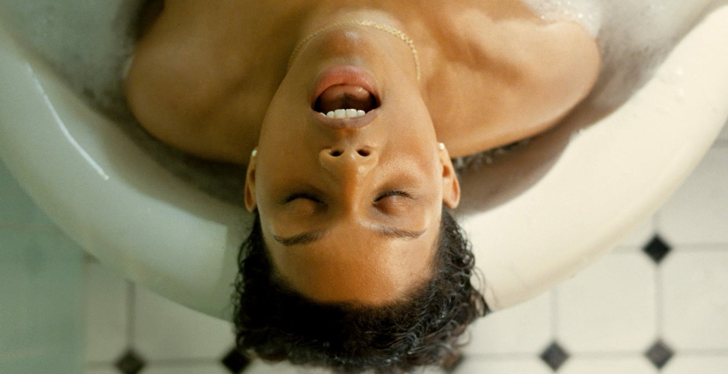 A woman relaxing in a bathtub, surrounded by bubbles and candles, enjoying a moment of tranquility  