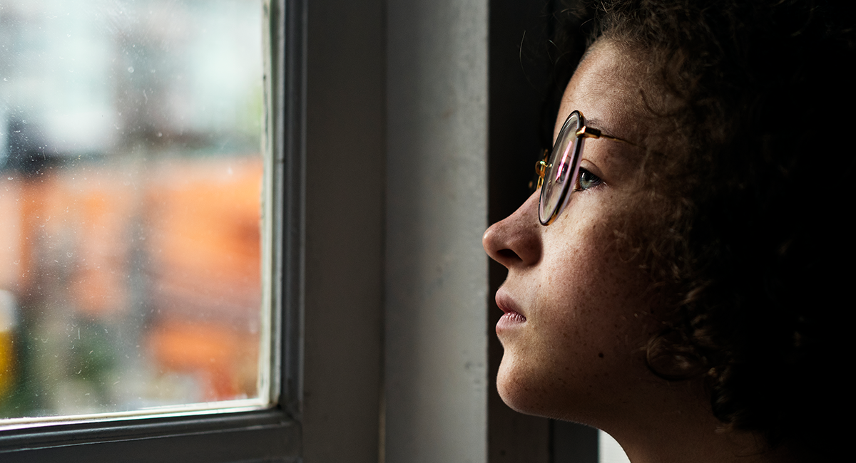 girl looking out a window 