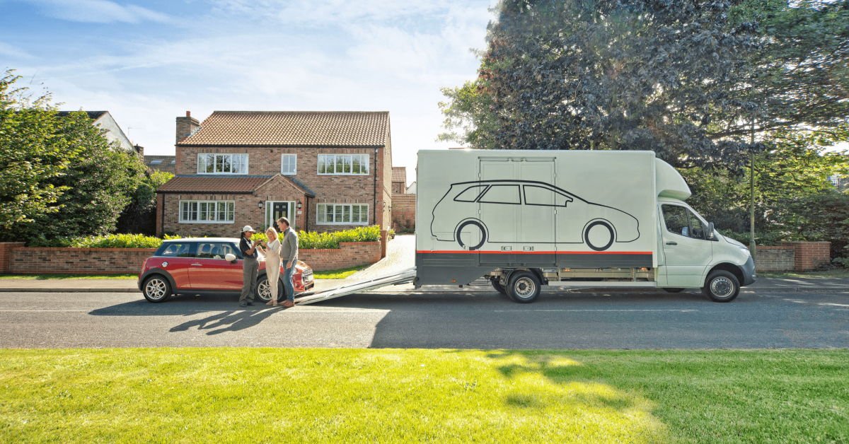 A car delivery scene in a suburban neighborhood, where a couple is receiving their red Mini Cooper. 