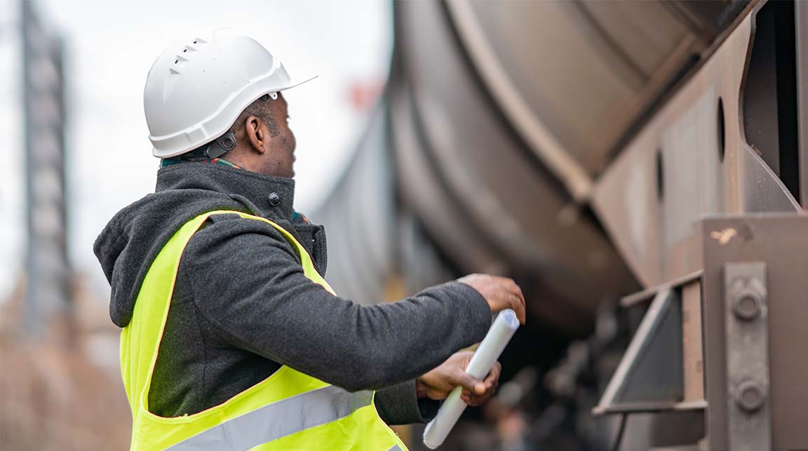 Middle-aged Black man working in yellow safety vest and hard hat