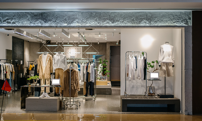 Contemporary clothing store with digital displays and stylish apparel racks, highlighting unified omnichannel retail experiences.