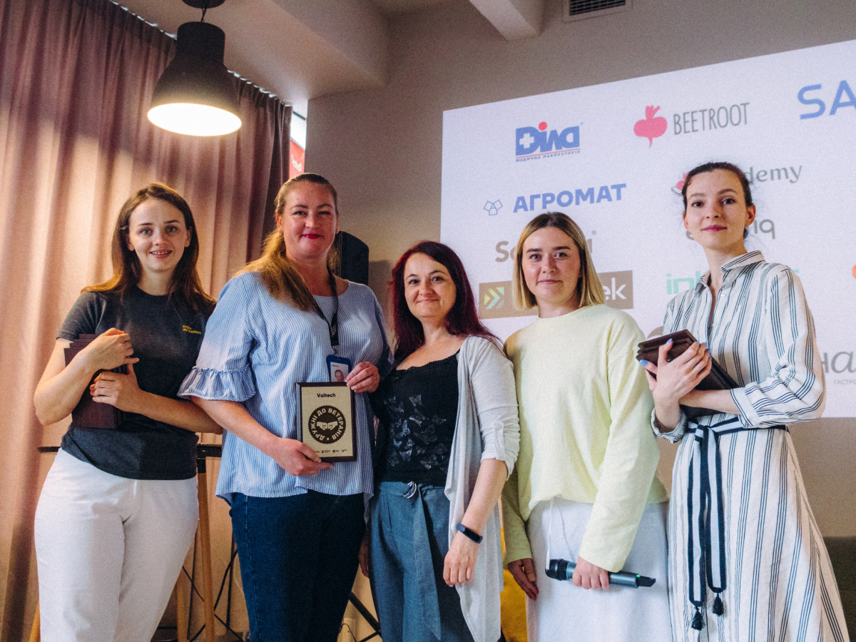 Five females standing next to each other posing with Valtech's earned Veteran Friendly Award from Veteran Hub