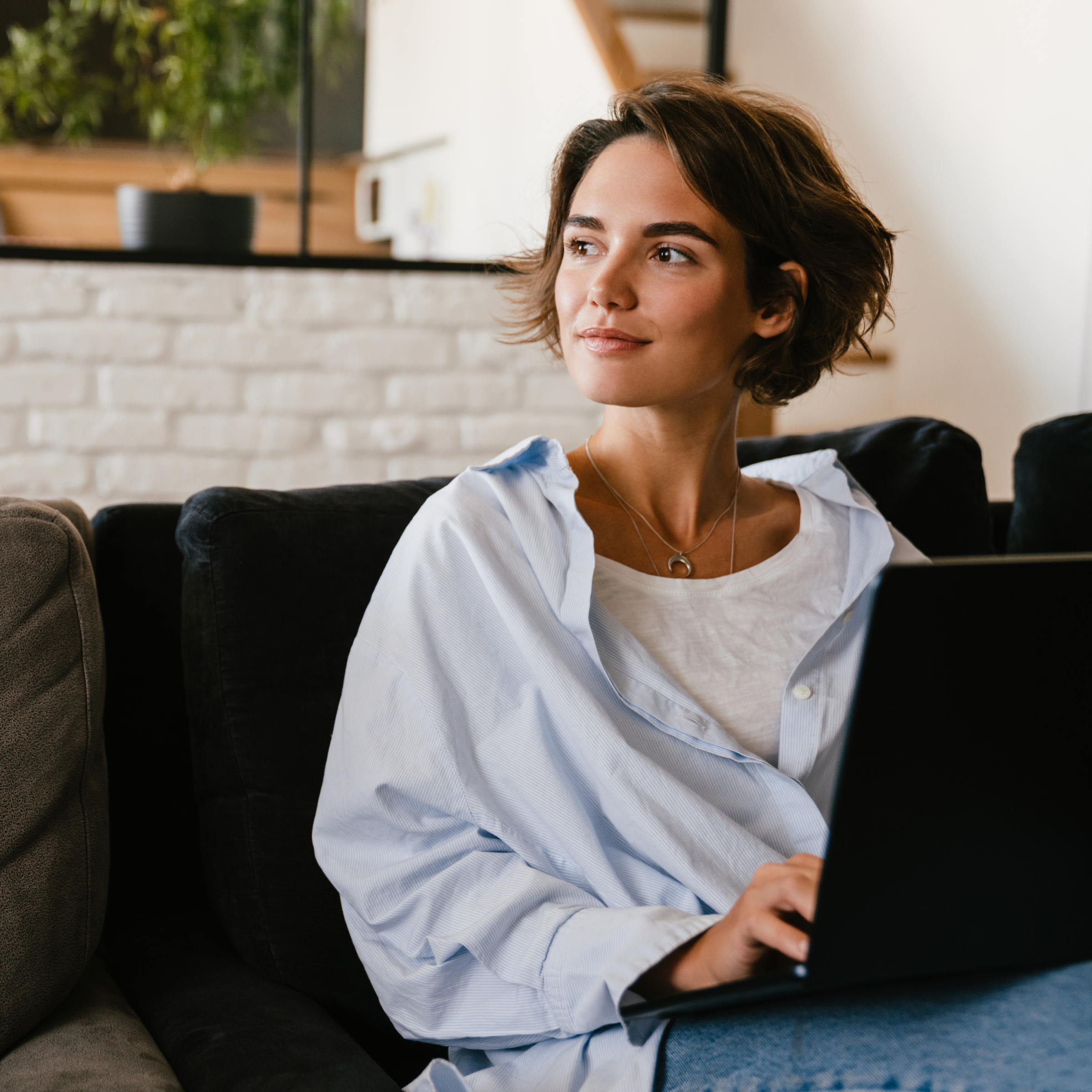 Transformative partnership woman on sofa with laptop